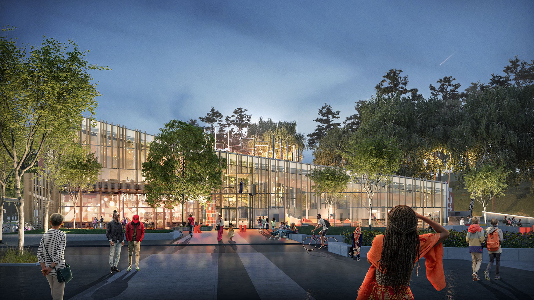 Ett öppet torg där människor i olika åldrar strosar omkring. Torget leder fram till en stor glasbyggnad med snedtak. Runt byggnaden finns träd och grönska.