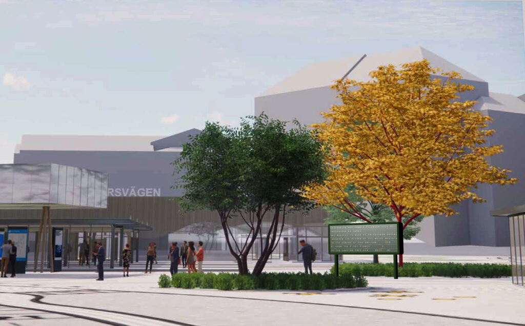 Utanför Korsvägens station syns en klafftavla som står mellan några träd. Människor rör sig runtomkring.