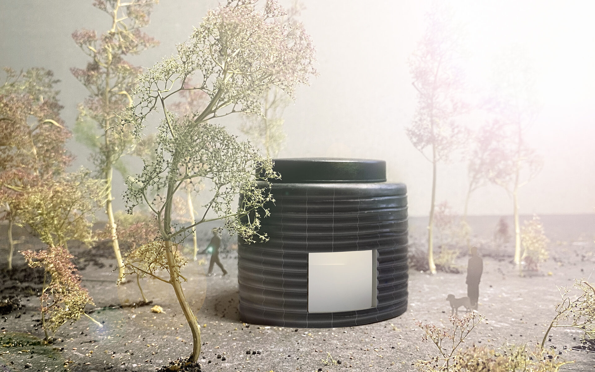 En modell av den runda paviljongen med ett tittfönster på ena sidan. Bredvid står en människa med sin hund.