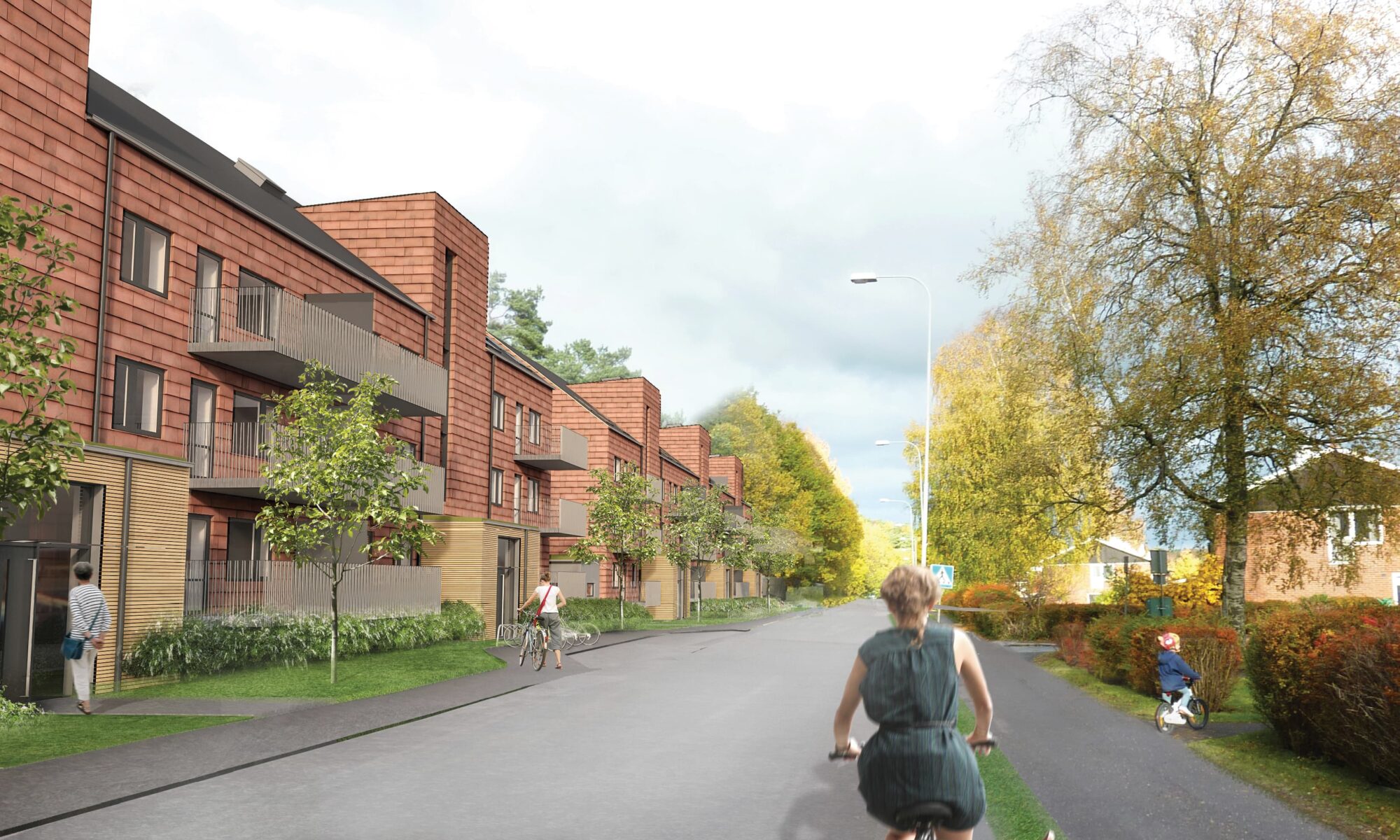 En kvinna cyklar längs en gata kantad av bostadshus och grönskande träd.